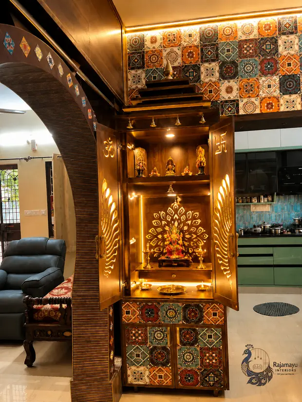 Pooja unit framed by a tiled arch by Rajamayu Interiors