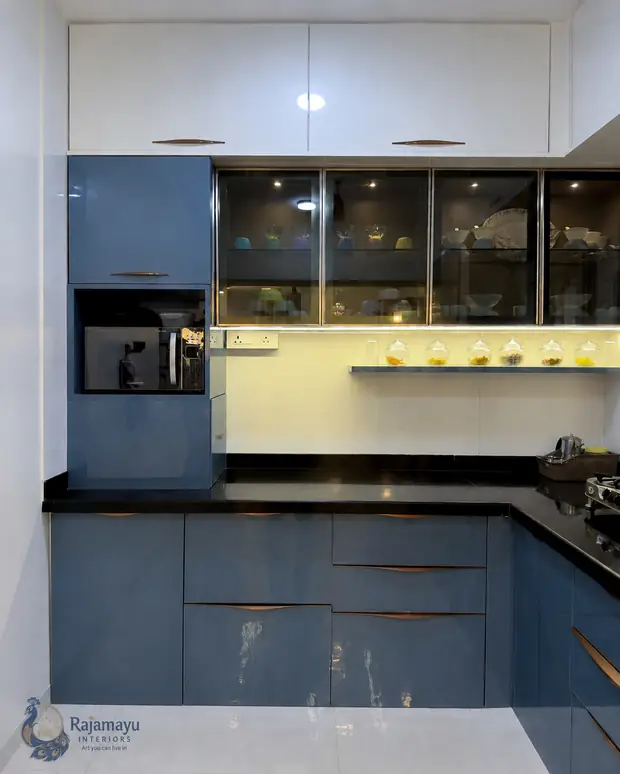 Kitchen in blue with glass shutters by Rajamayu Interiors