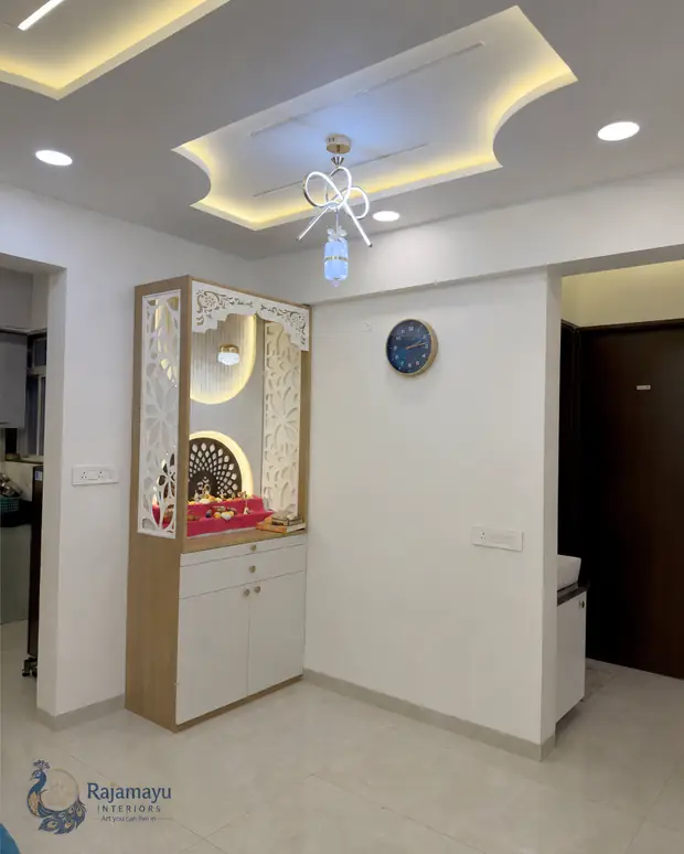 Pooja unit with jaali doors and cove lighting