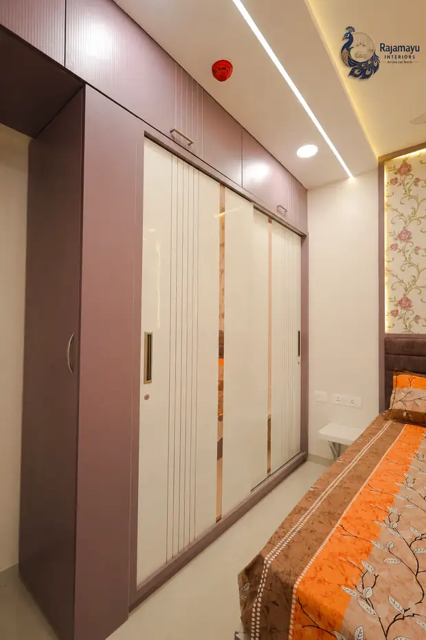 Wardrobe with panelled shutters by Rajamayu Interiors