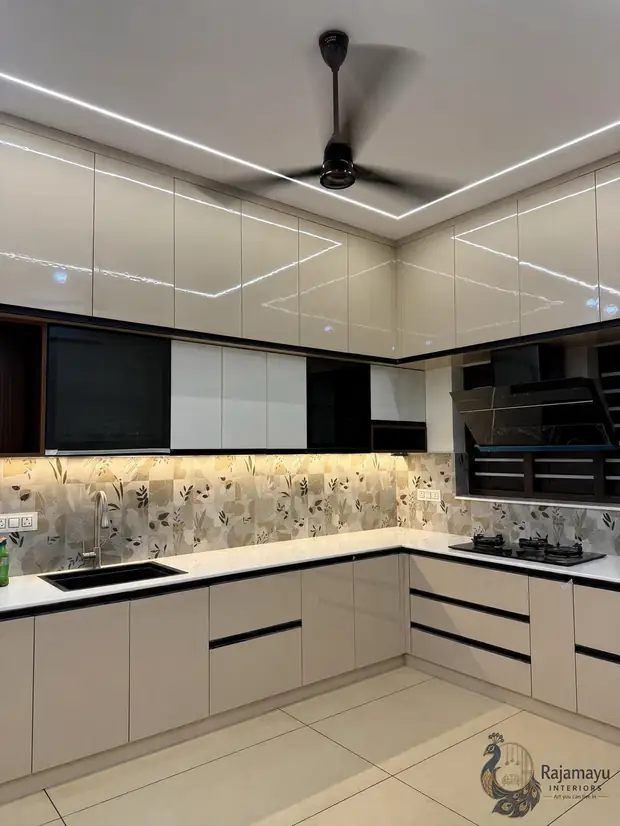Kitchen with patterned backsplash by Rajamayu Interiors