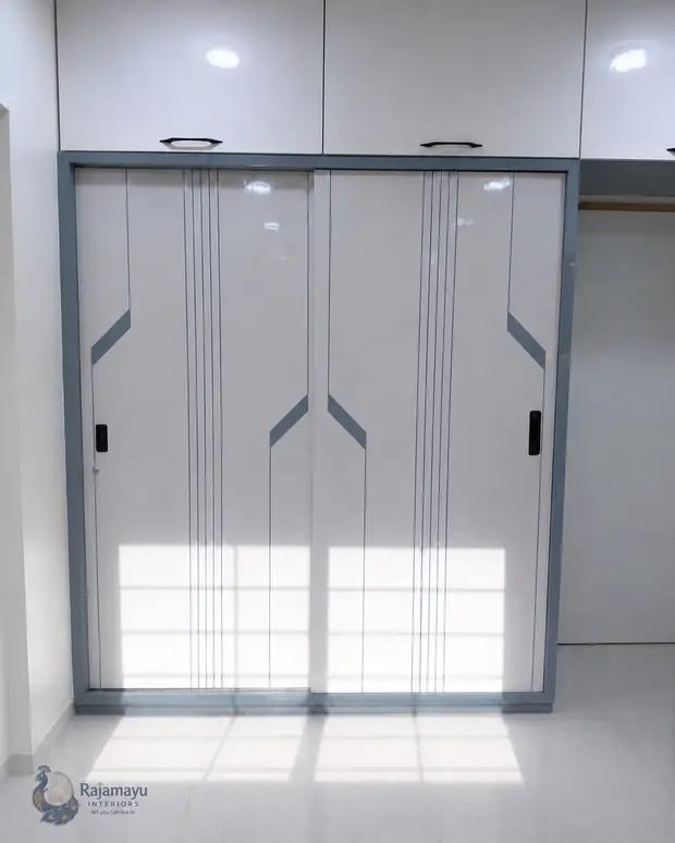Three-door sliding wardrobe by Rajamayu Interiors