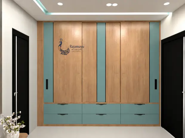Wardrobe in teak and teal by Rajamayu Interiors